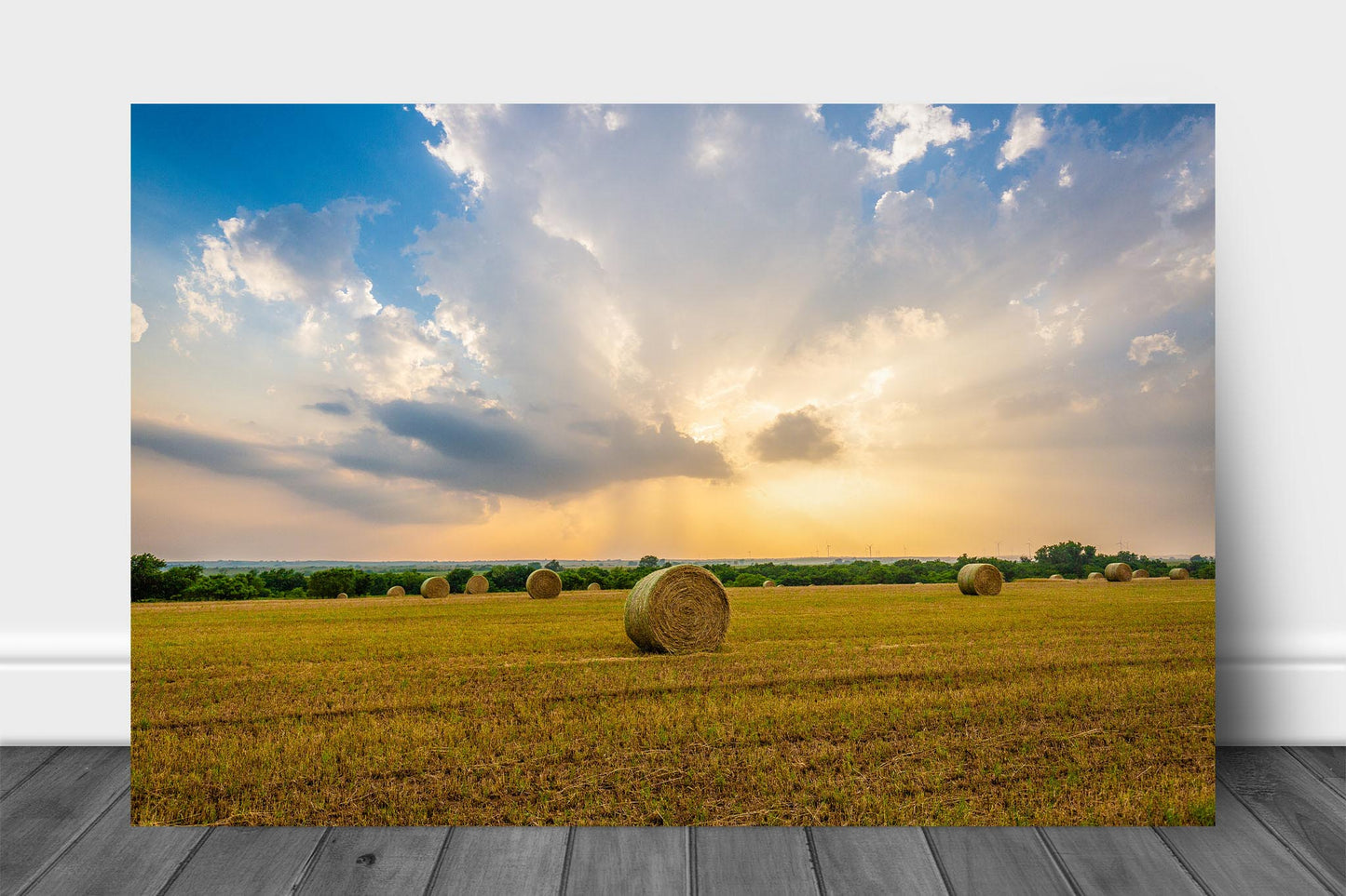 Country metal print wall art on aluminum of round hay bales in a field under a golden stormy sky at sunset in Oklahoma by Sean Ramsey of Southern Plains Photography.