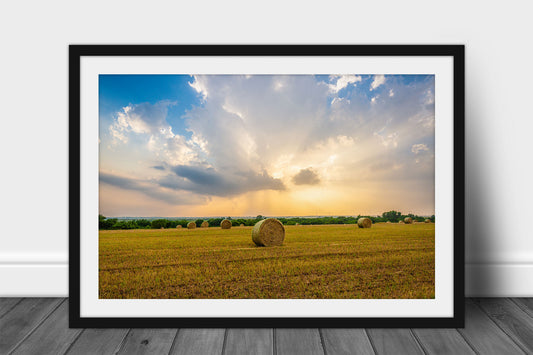 Framed and matted country print of a stormy sky in evening sunlight over a round hay bale in a field in Oklahoma by Sean Ramsey of Southern Plains Photography. 