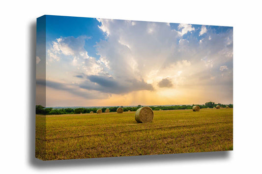 Country canvas wall art of a stormy sky in evening sunlight over a round hay bale in a field in Oklahoma by Sean Ramsey of Southern Plains Photography. 