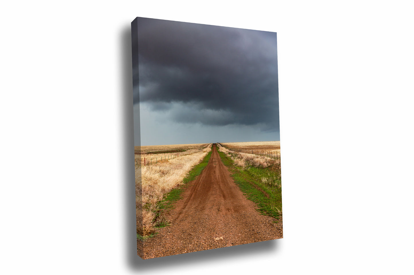 Vertical country canvas wall art of a dirt road leading to a stormy sky on a spring day in Texas by Sean Ramsey of Southern Plains Photography.