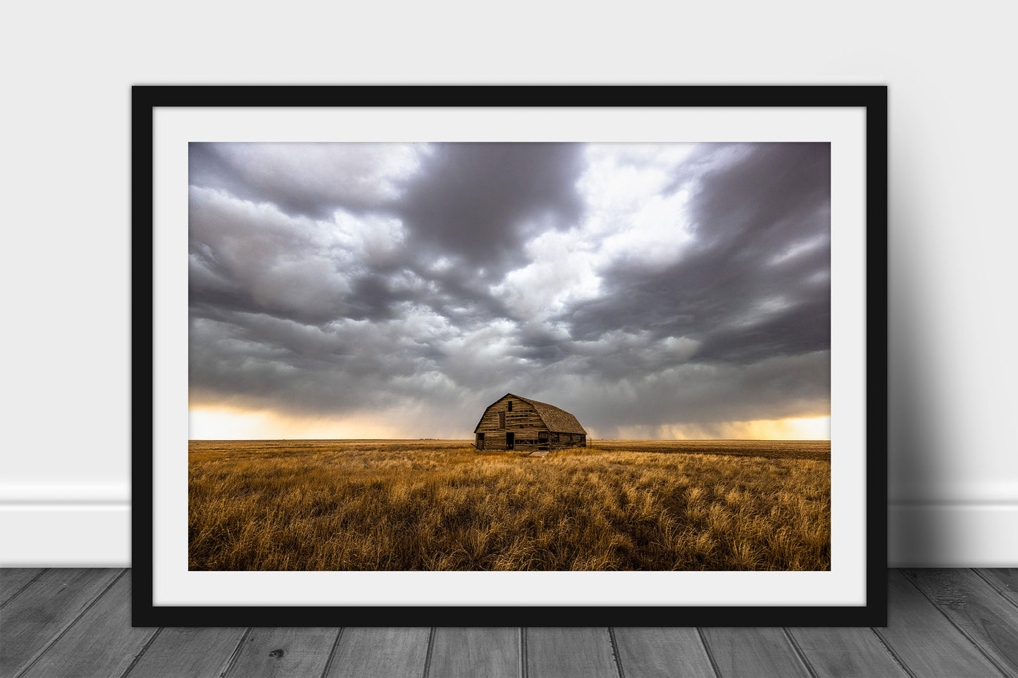 Framed and matted Great Plains print of an old barn nestled in golden prairie grass under a stormy sky on a spring day in Oklahoma by Sean Ramsey of Southern Plains Photography.