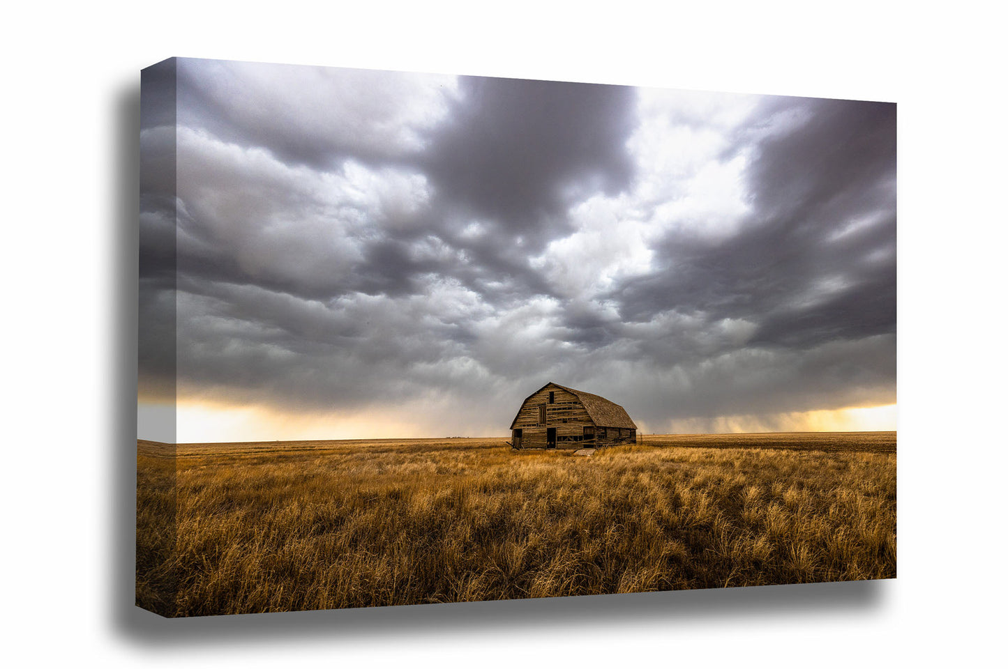 Great Plains canvas wall art of an old barn nestled in golden prairie grass under a stormy sky on a spring day in Oklahoma by Sean Ramsey of Southern Plains Photography.