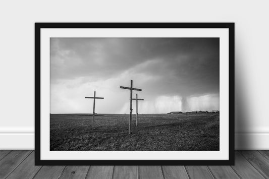 Framed and matted spiritual print in black and white of three wooden crosses on a stormy day in Texas by Sean Ramsey of Southern Plains Photography.