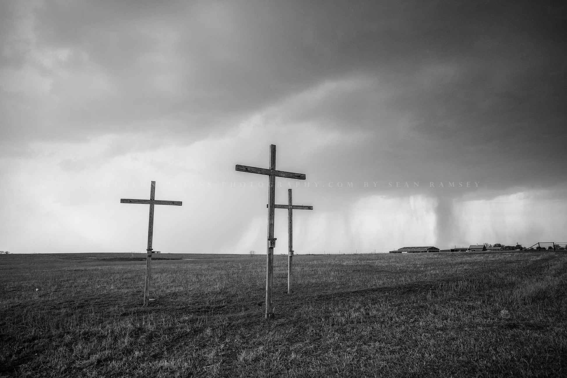 Spiritual black and white photography print of three wooden crosses standing tall as a thunderstorm passes through on a stormy spring day in Texas by Sean Ramsey of Southern Plains Photography.