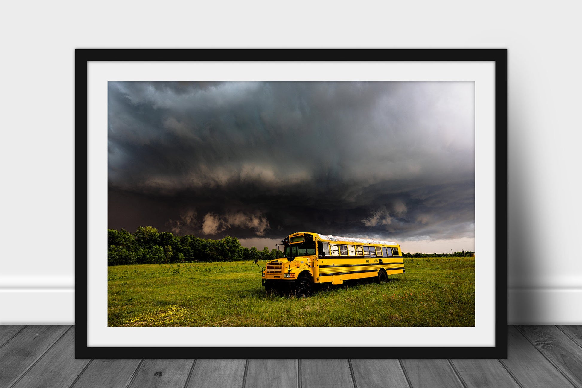 Framed and matted storm print of a thunderstorm advancing over an old abandoned school bus on a stormy spring day in Oklahoma by Sean Ramsey of Southern Plains Photography.