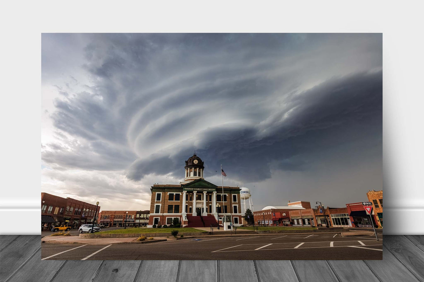 Storm aluminum metal print wall art of a striated supercell thunderstorm advancing over the Washita County courthouse in Cordell, Oklahoma by Sean Ramsey of Southern Plains Photography.