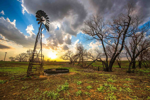 Country photography print of an old windmill and charred trees at sunset on a spring evening in Kansas by Sean Ramsey of Southern Plains Photography.