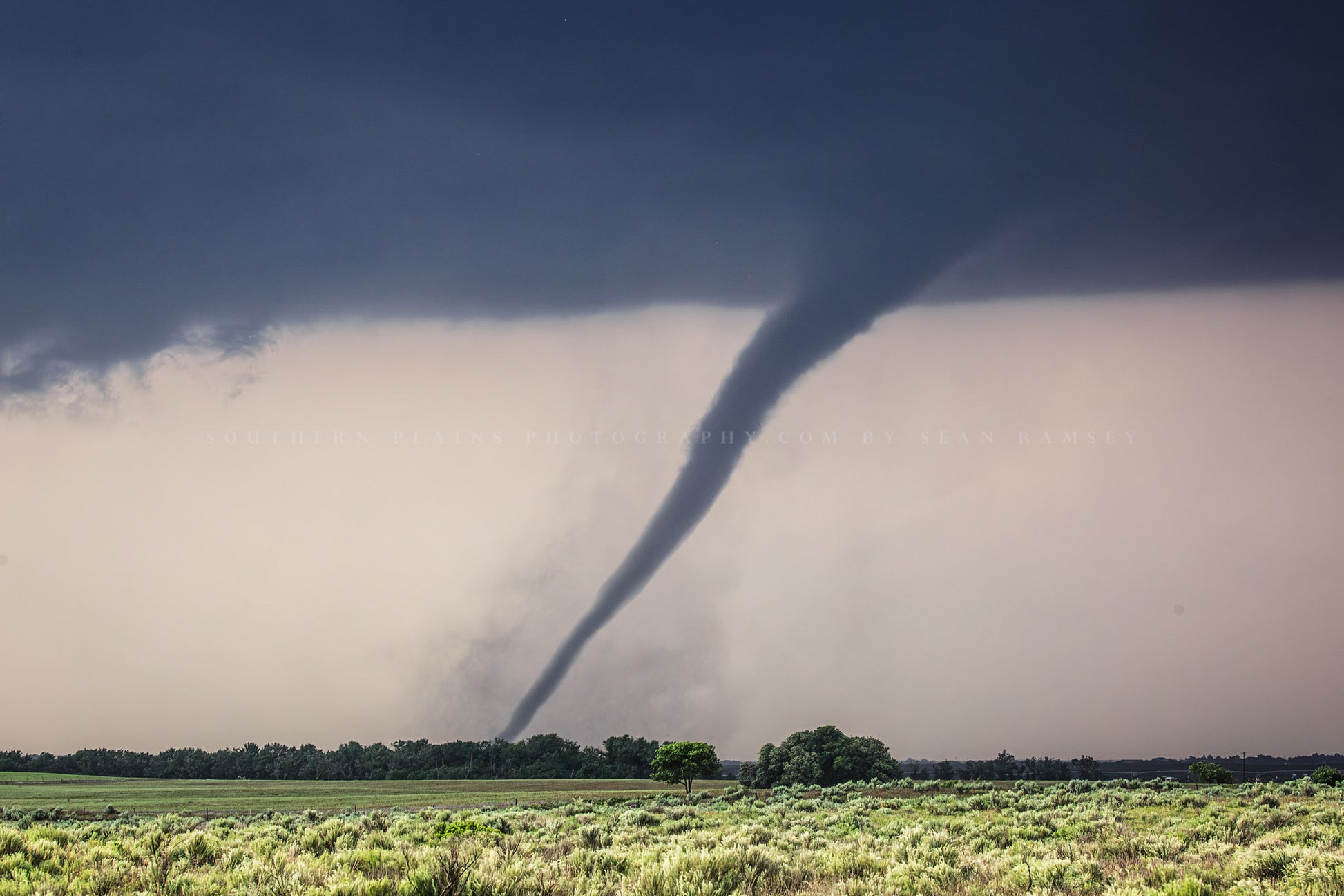 Extreme weather photography print of a tornado twisting over open prairie on a stormy day in Oklahoma by Sean Ramsey of Southern Plains Photography.