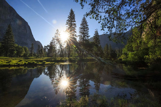 Nature photography print of the sun reflecting off the waters of the Merced River on a peaceful summer morning in Yosemite National Park, California by Sean Ramsey of Southern Plains Photography.