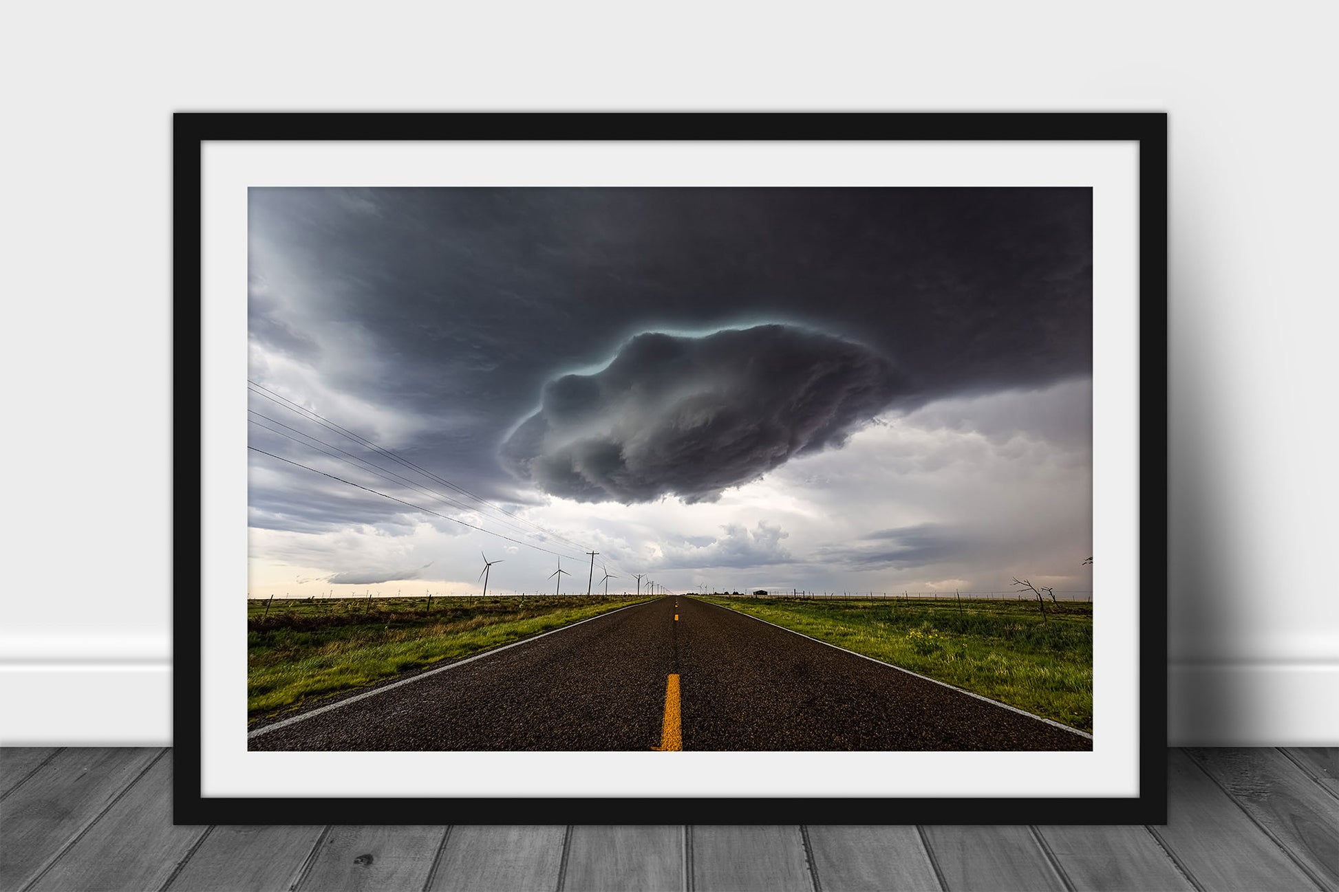 Framed and matted storm print of a supercell thunderstorm wall cloud appearing as a UFO over a highway on a stormy spring day in New Mexico by Sean Ramsey of Southern Plains Photography.
