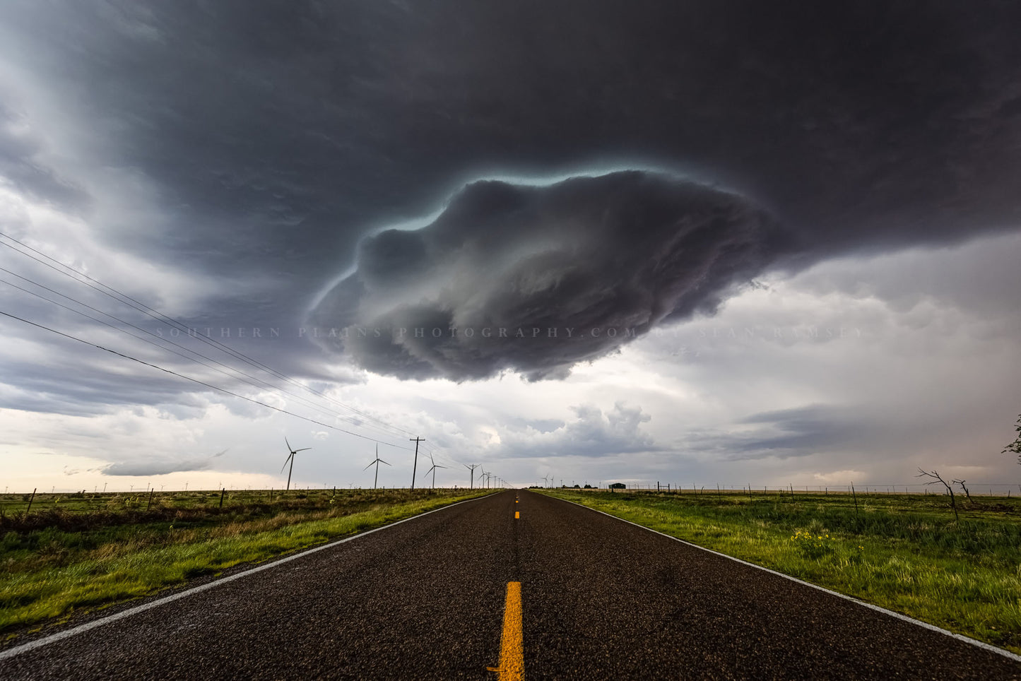 Storm photography print of a supercell thunderstorm wall cloud appearing as a UFO over a highway on a stormy spring day in New Mexico by Sean Ramsey of Southern Plains Photography.
