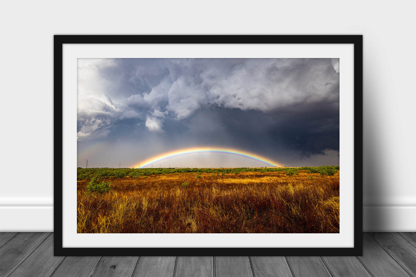 Framed and matted thunderstorm print of a vibrant rainbow low to the horizon on a stormy day on the plains of Texas by Sean Ramsey of Southern Plains Photography.