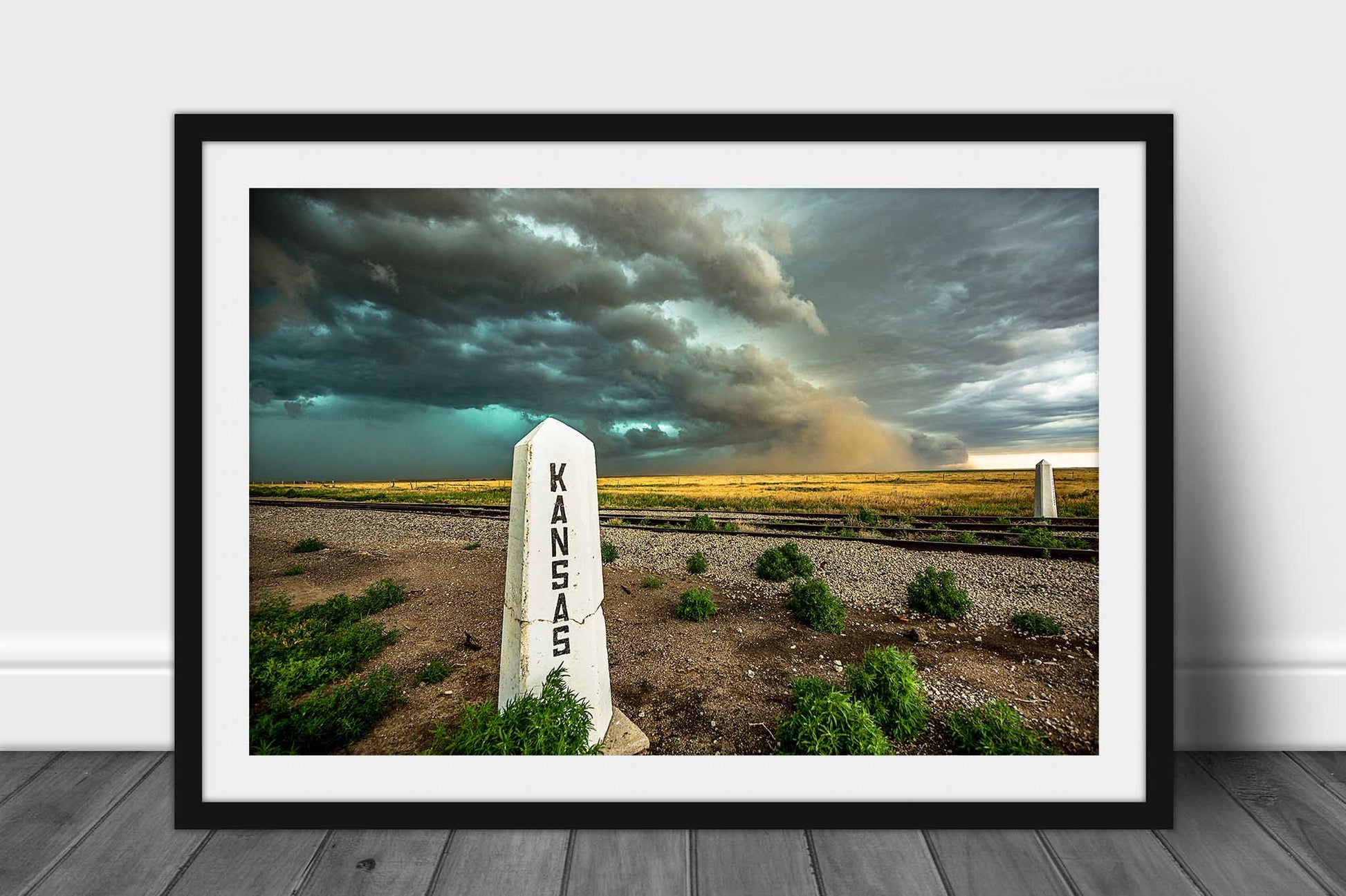 Framed and matted Great Plains print of a haboob thunderstorm advancing past a railroad post at the state line of Kansas and Colorado by Sean Ramsey of Southern Plains Photography.