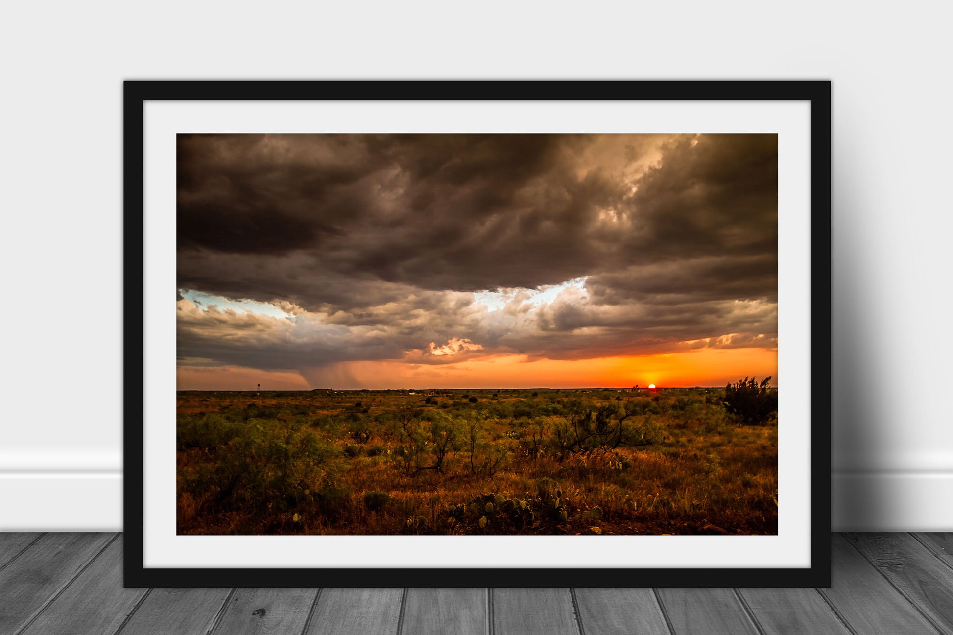 Framed western landscape print of a warm sunset taking place over cactus and mesquite bushes on a stormy spring evening in West Texas by Sean Ramsey of Southern Plains Photography.
