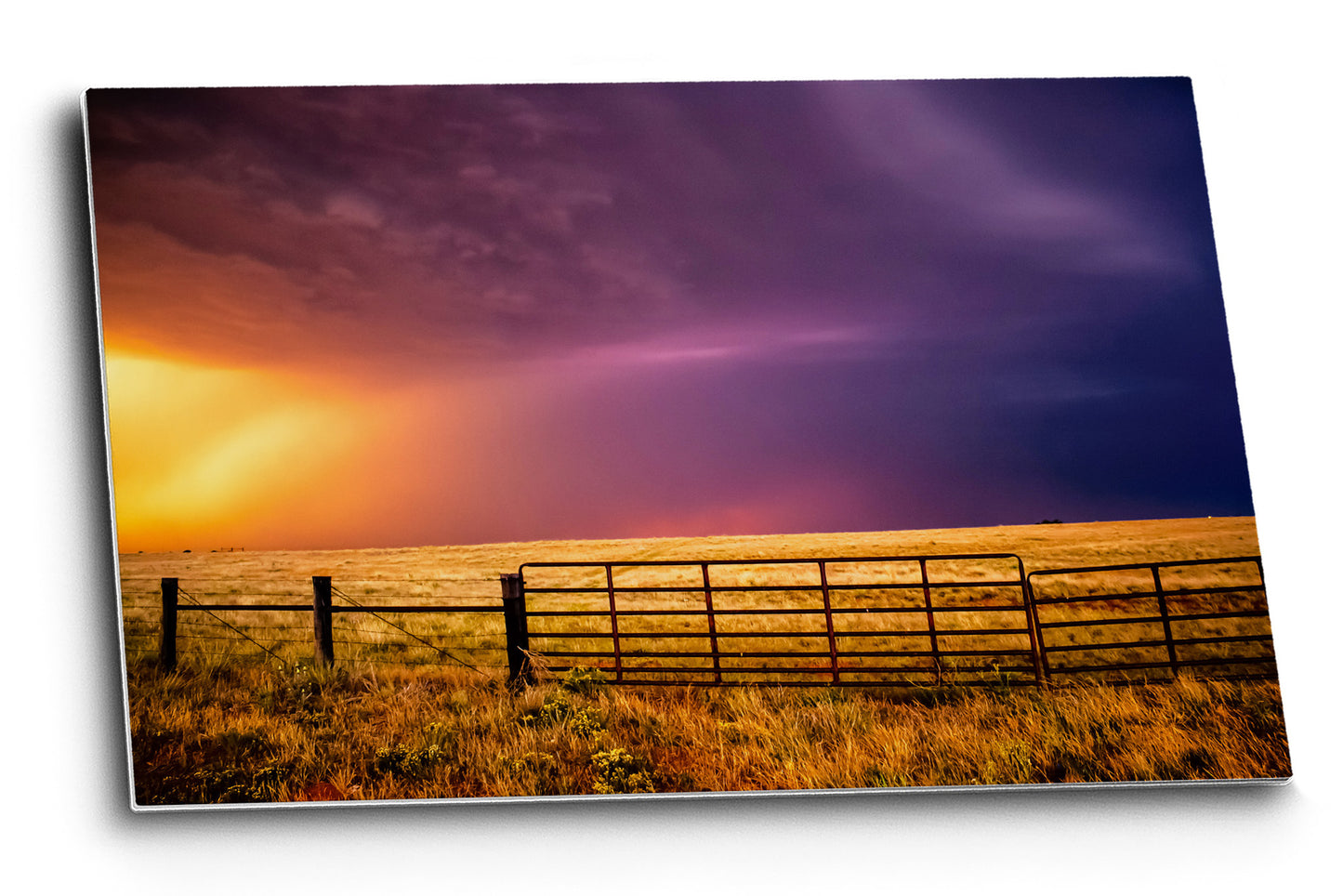 Western aluminum metal print wall art of a colorful sky over a fence gate on a stormy summer evening in Oklahoma by Sean Ramsey of Southern Plains Photography.