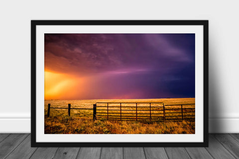 Framed and matted western print of a colorful stormy sky over a fence gate at sunset on a summer evening in Oklahoma by Sean Ramsey of Southern Plains Photography.