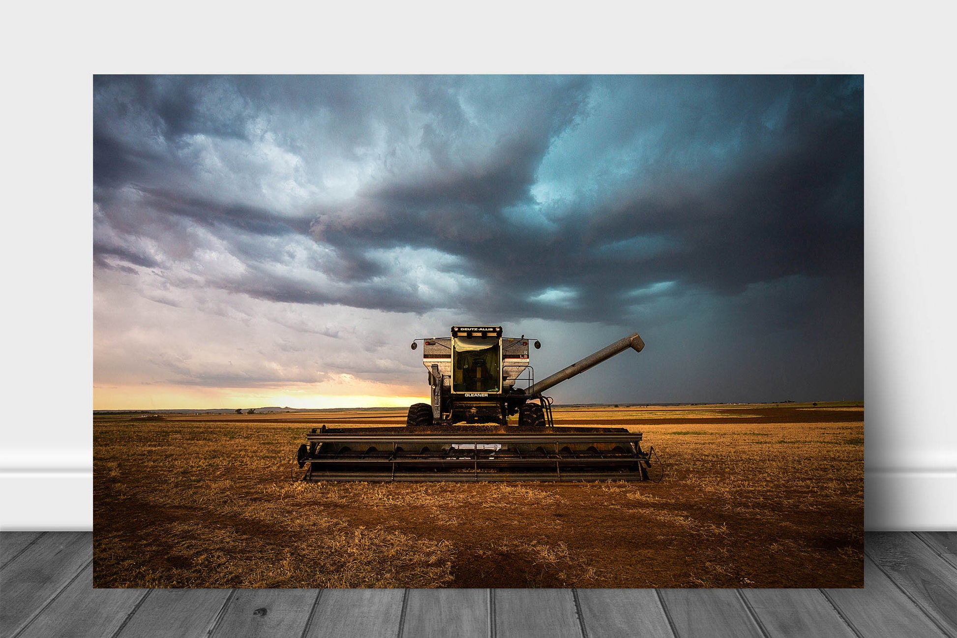 Agriculture metal print on aluminum of a combine swather sitting in a field under storm clouds on a stormy day in Oklahoma by Sean Ramsey of Southern Plains Photography.