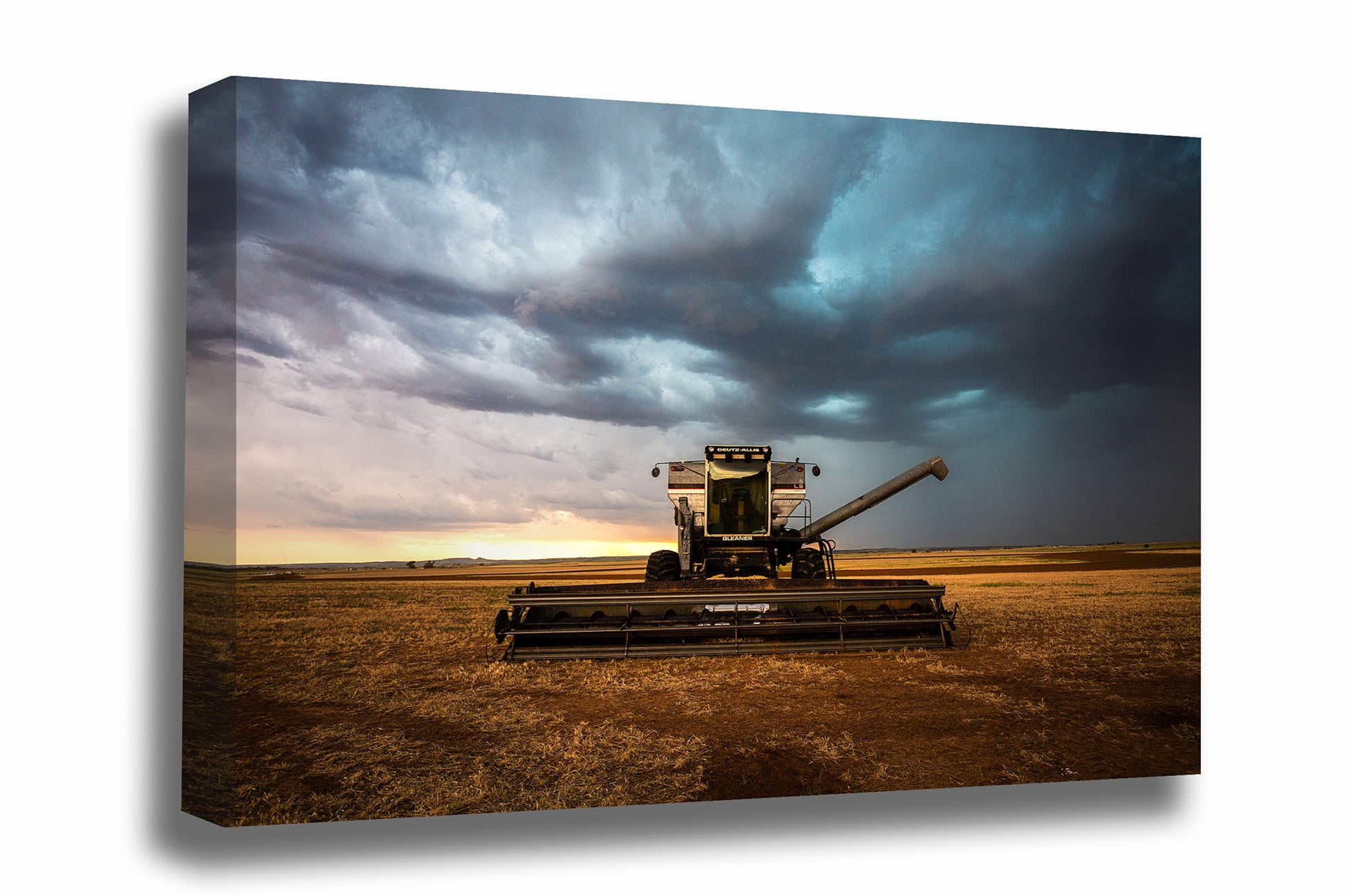 Farm canvas wall art of a combine swather sitting in a field under storm clouds on a stormy day in Oklahoma by Sean Ramsey of Southern Plains Photography.