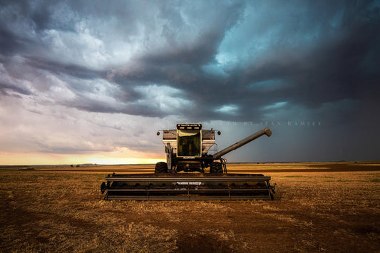 Farm photography print of a combine swather in a field as a thunderstorm advances overhead on a stormy summer day in Oklahoma by Sean Ramsey of Southern Plains Photography.