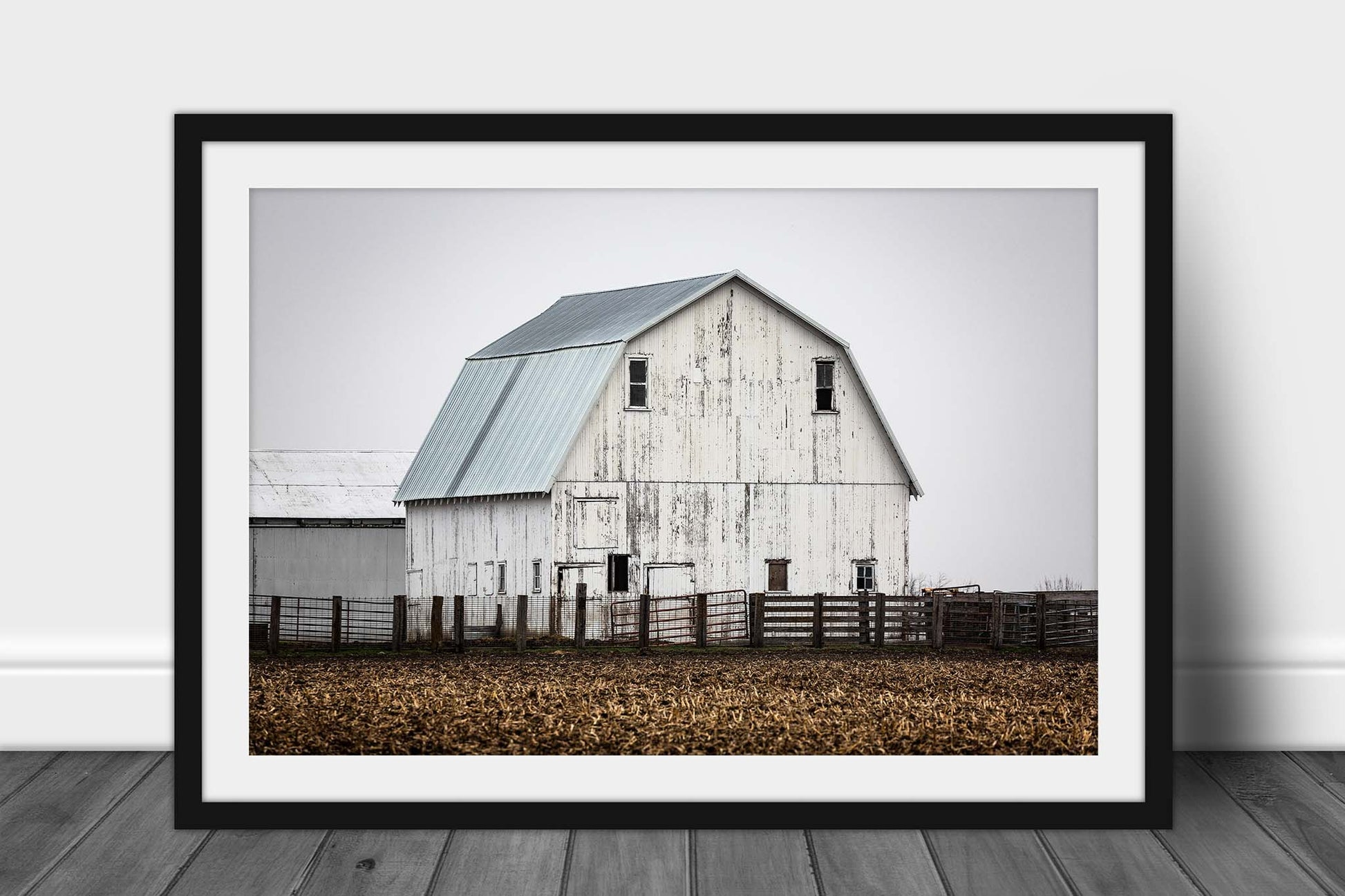 Framed and matted farm photography print of a rustic white barn against a gray sky on a foggy spring morning in Illinois by Sean Ramsey of Southern Plains Photography.