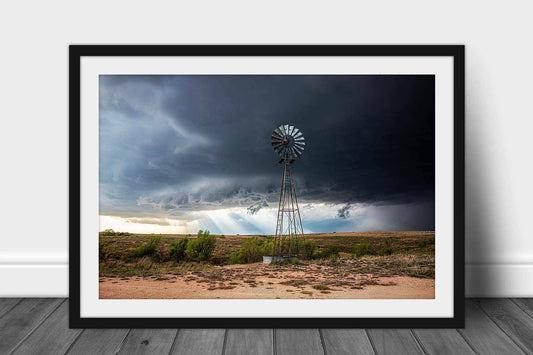 Framed and matted country print of sunbeams breaking through a thunderstorm as a windmill stands tall on the Texas prairie by Sean Ramsey of Southern Plains Photography.