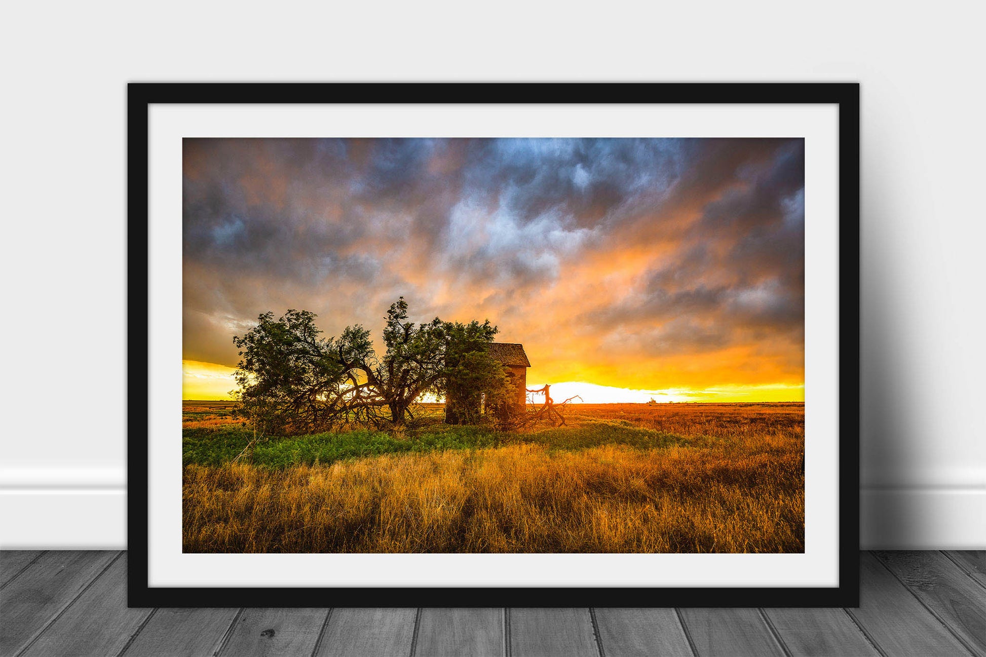 Framed and matted prairie print of a stormy sunset taking place over an old barn and windswept tree on the plains of Oklahoma by Sean Ramsey of Southern Plains Photography.