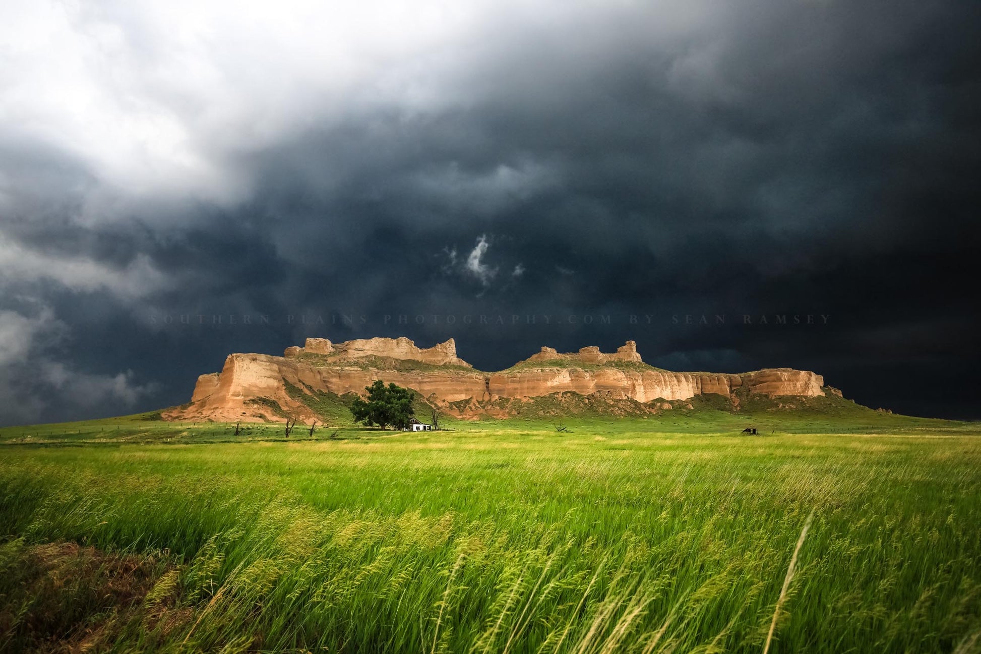 Great plains landscape photography print of storm clouds over a bluff along Wright's Gap Road on a stormy spring day near Scottsbluff, Nebraska by Sean Ramsey of Southern Plains Photography.
