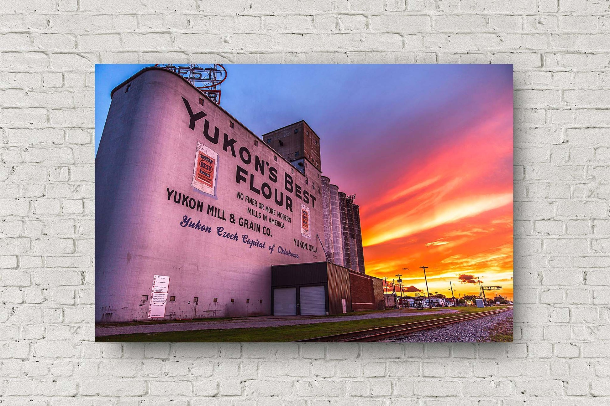 Route 66 metal print of a vivid sunset taking place behind the Yukon's Best grain elevator in Yukon, Oklahoma by Sean Ramsey of Southern Plains Photography.