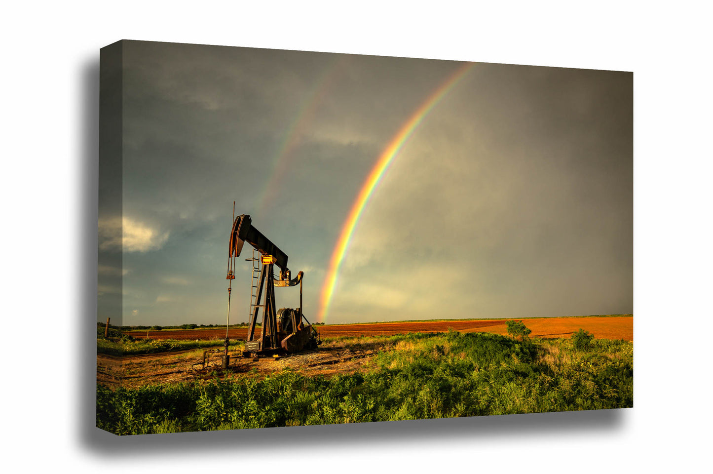 Oilfield canvas wall art of a brilliant rainbow ending at a pump jack after a stormy spring day on the plains of Texas by Sean Ramsey of Southern Plains Photography.