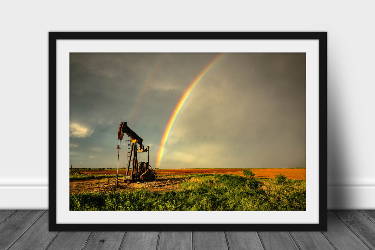 Framed and matted oilfield photography print of a brilliant rainbow ending at a pump jack on a stormy spring day on the plains of Texas by Sean Ramsey of Southern Plains Photography.