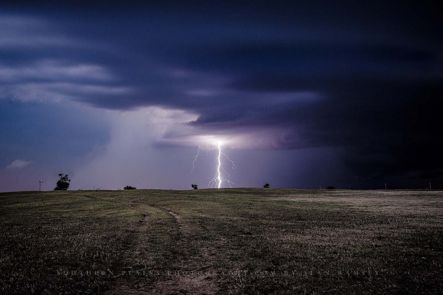 Storm photography print of a branched lightning bolt striking the plains on a stormy night in Oklahoma by Sean Ramsey of Southern Plains Photography.