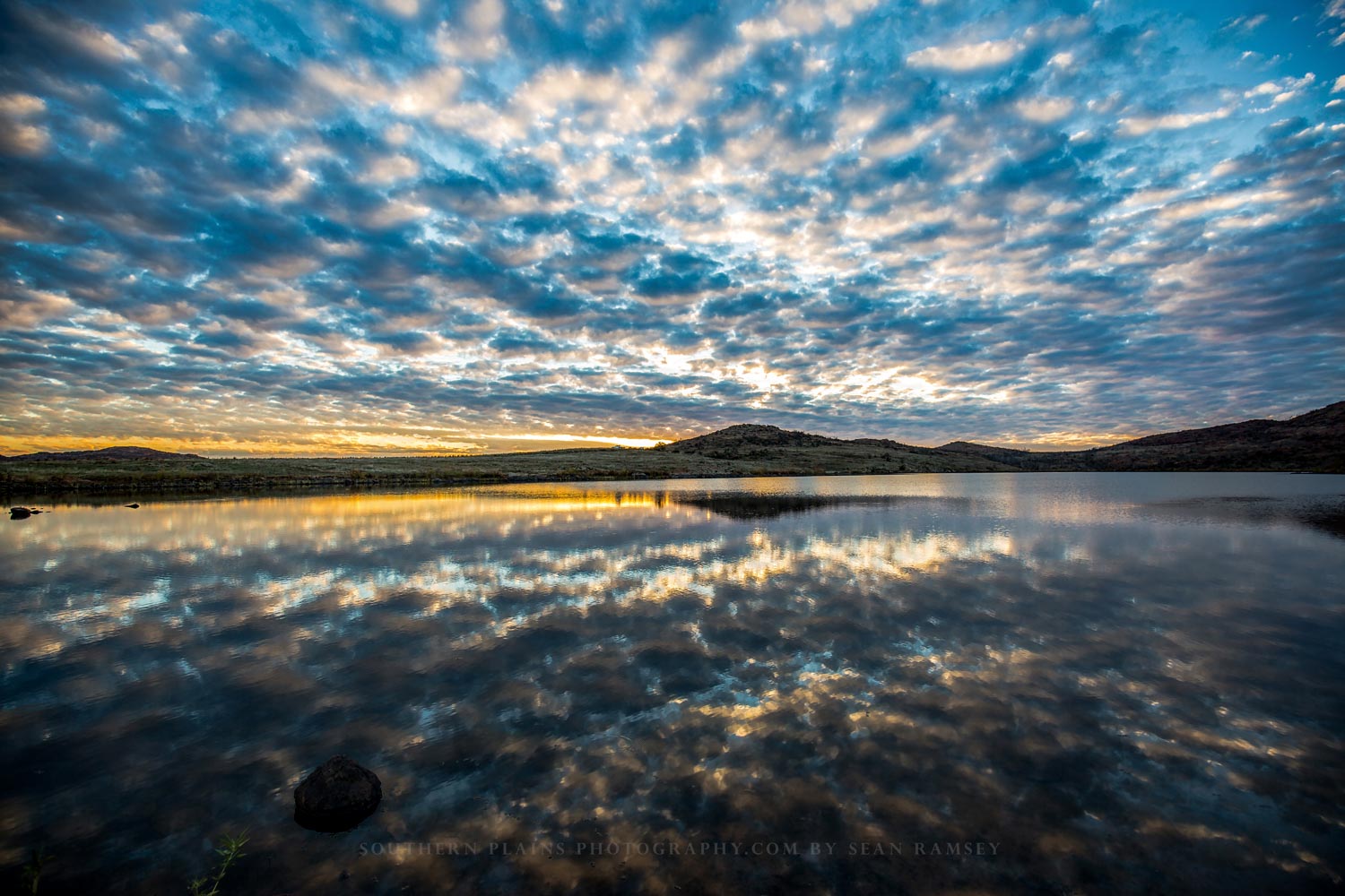 Landscape photography print of clouds reflecting off the waters of Lake Jed Johnson at sunset in the Wichita Mountains near Lawton, Oklahoma by Sean Ramsey of Southern Plains Photography.