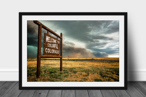 Framed storm print with optional mat of a haboob thunderstorm carrying dust behind a Colorful Colorado state line sign on a stormy spring day along the Colorado and Kansas border by Sean Ramsey of Southern Plains Photography.