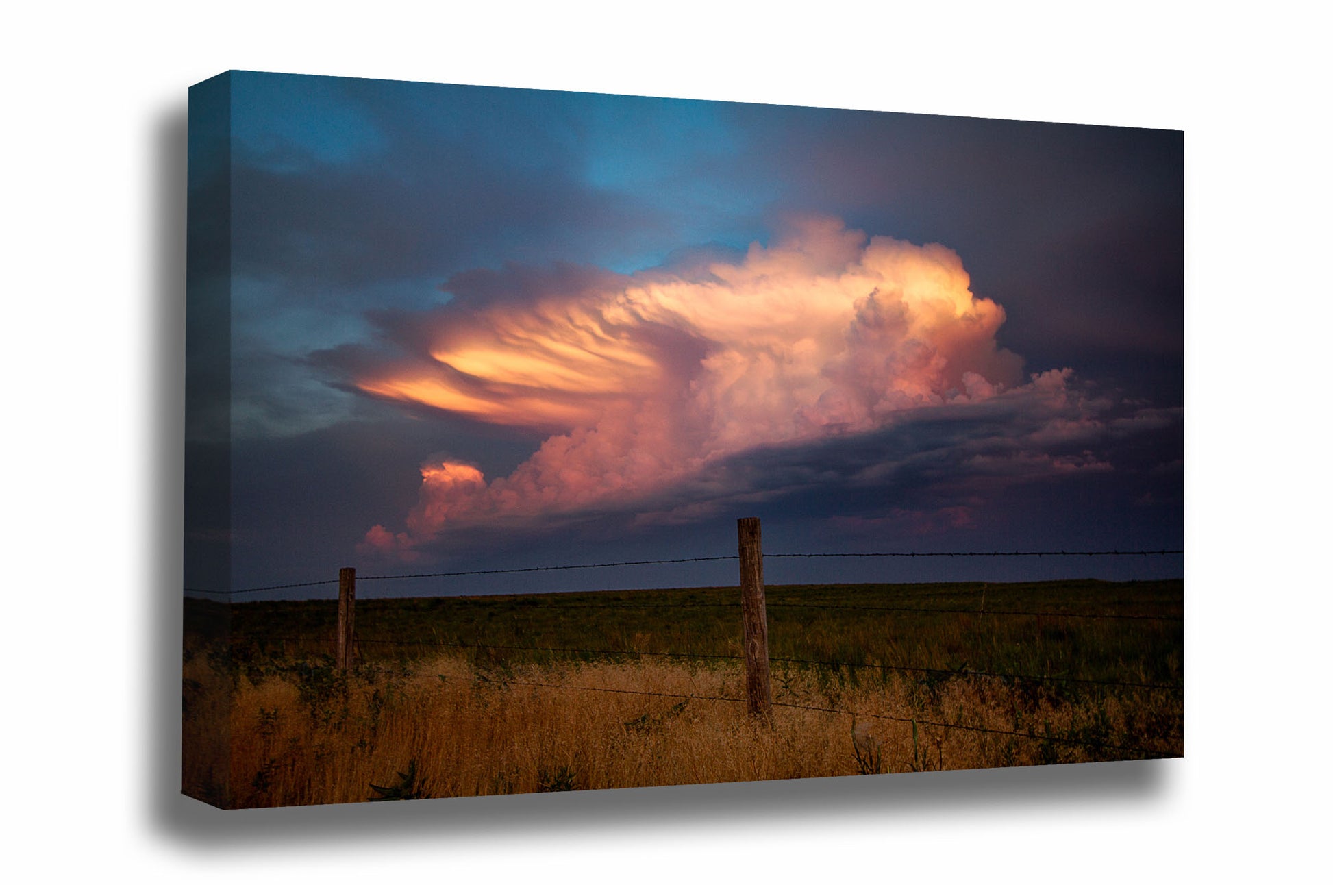 Western canvas wall art of a distant storm cloud drenched in evening sunlight over a barbed wire fence at sunset on a stormy spring evening in Oklahoma by Sean Ramsey of Southern Plains Photography.