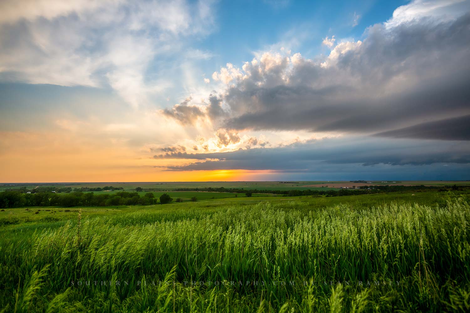 A scenic sunset takes places as a thunderstorm moves over the open prairie on a spring evening in Kansas.