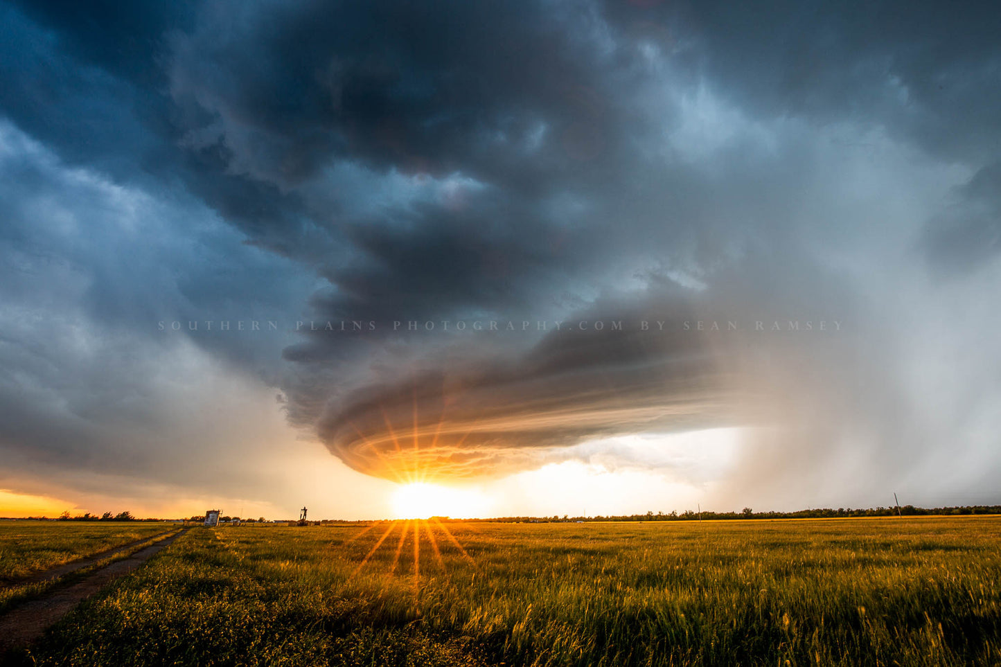Storm photography print of a supercell thunderstorm advancing over a field as the sun twinkles over the landscape on a stormy spring evening in Oklahoma by Sean Ramsey of Southern Plains Photography.