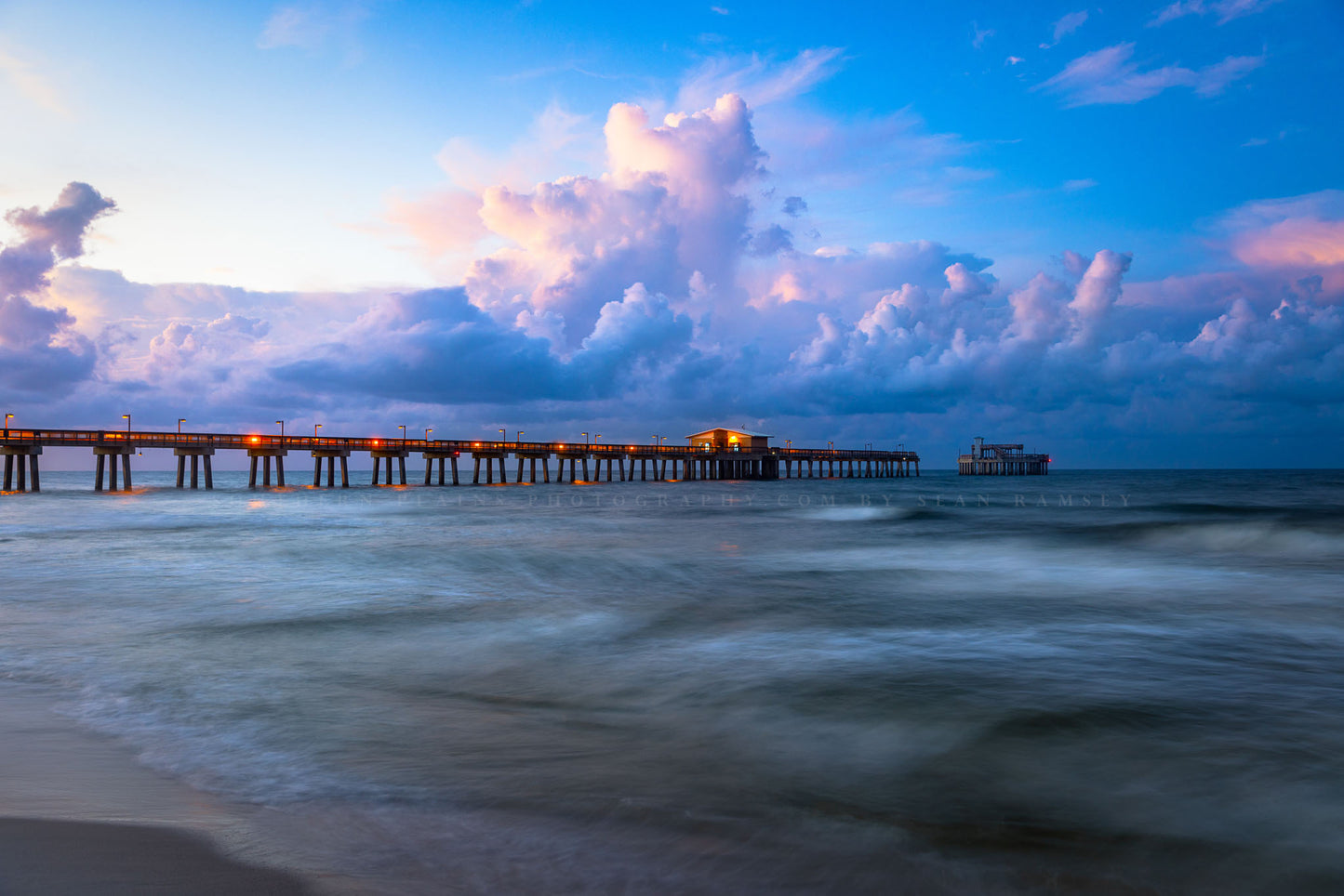 Gulf Coast photography print of the Gulf State Park Pier as waves roll ashore along a beach at sunrise in Gulf Shores, Alabama by Sean Ramsey of Southern Plains Photography.