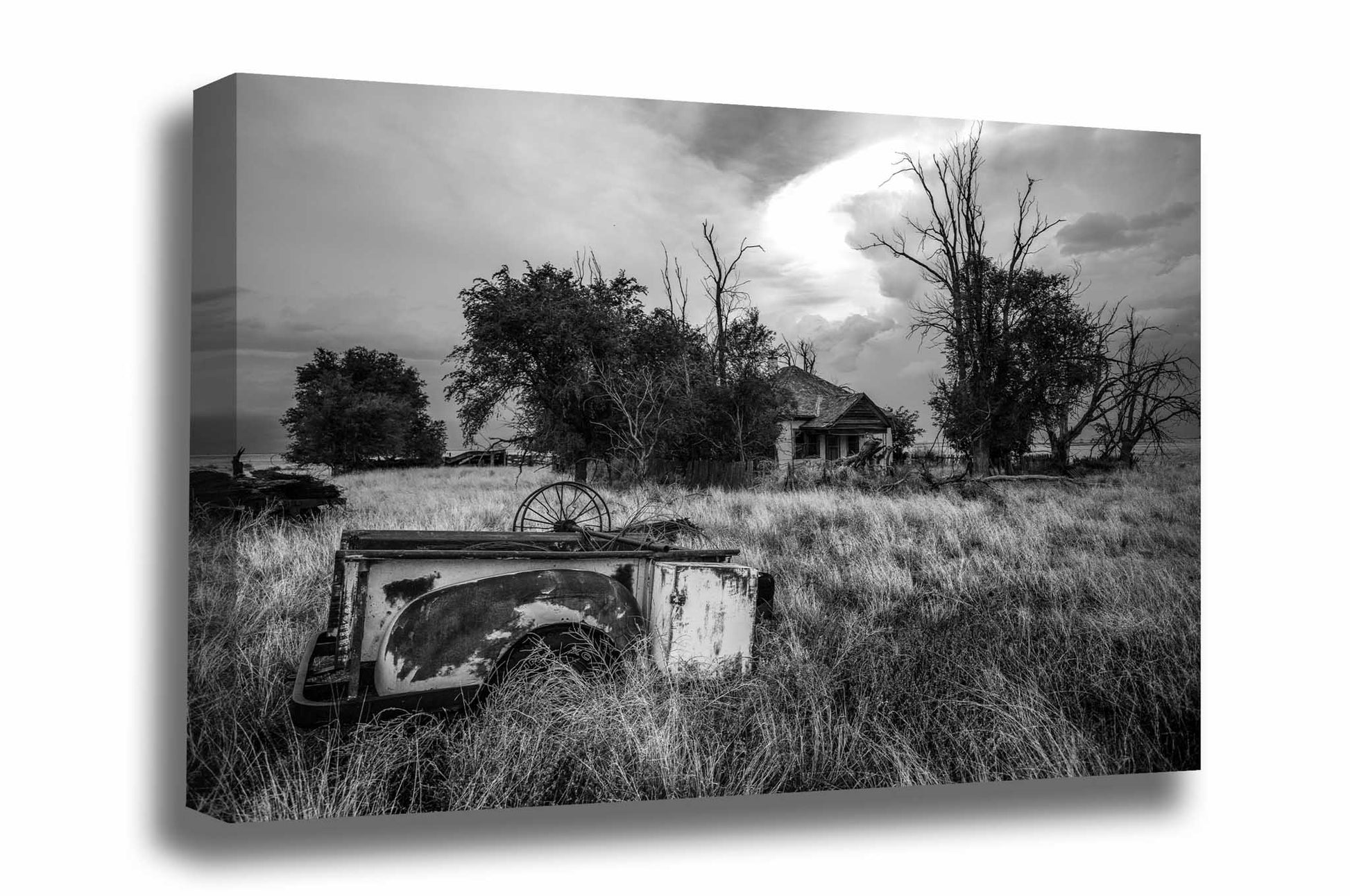 Country canvas wall art of a rusty pickup bed in the front yard of an abandoned homestead on a spring day in Oklahoma in black and white by Sean Ramsey of Southern Plains Photography.