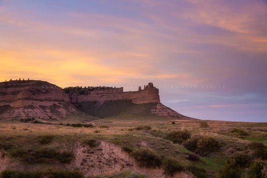 Western photography print of a bluff and prairie landscape under a warm sky at sunset on a summer evening in western Nebraska by Sean Ramsey of Southern Plains Photography.