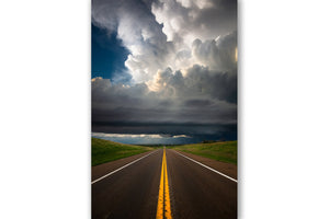 Vertical storm photography print of looking down the road as a supercell thunderstorm advances over a highway on a stormy spring day in Kansas by Sean Ramsey of Southern Plains Photography.