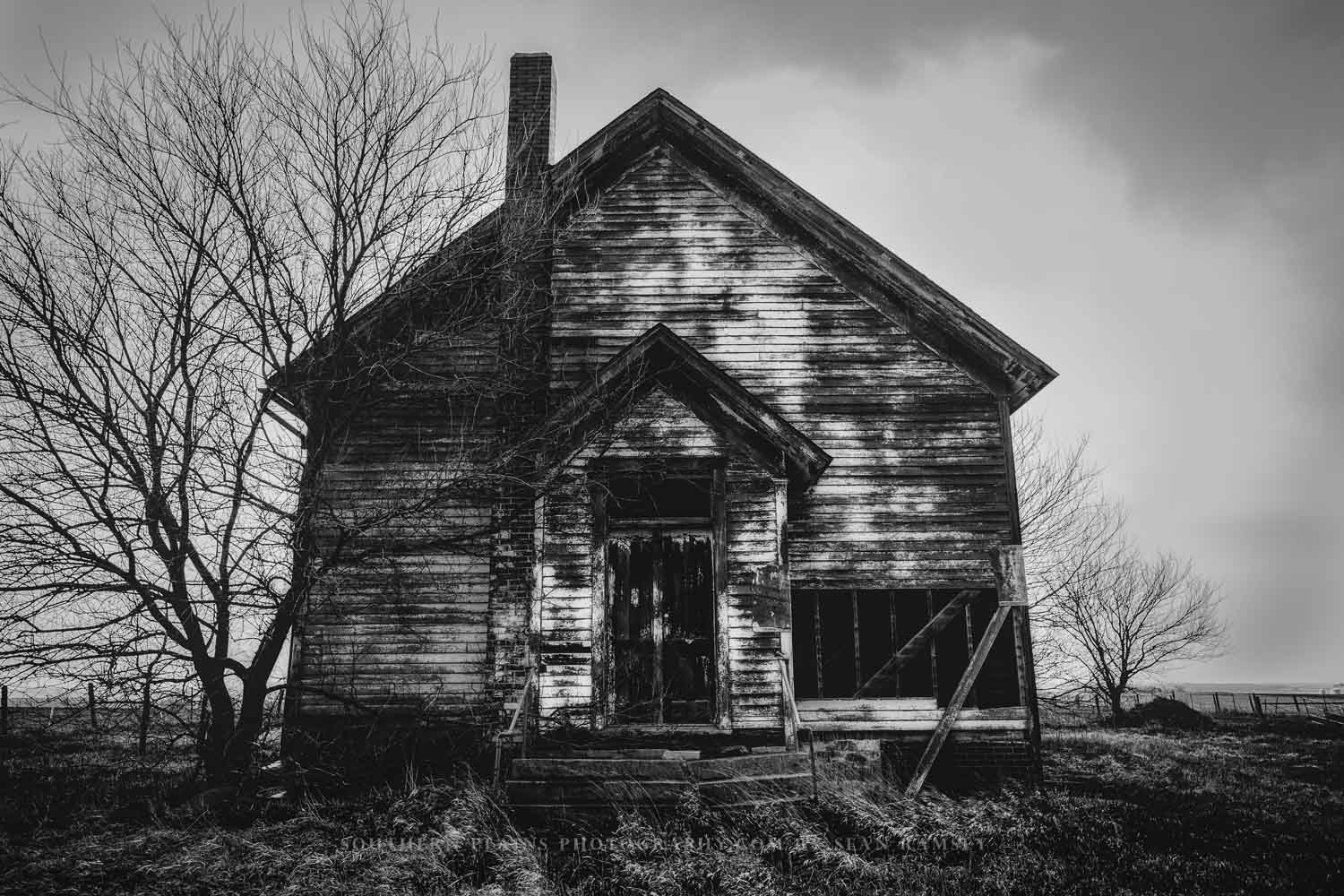 Black and white country photography print of an abandoned schoolhouse on a stormy spring day on the plains of Iowa by Sean Ramsey of Southern Plains Photography.