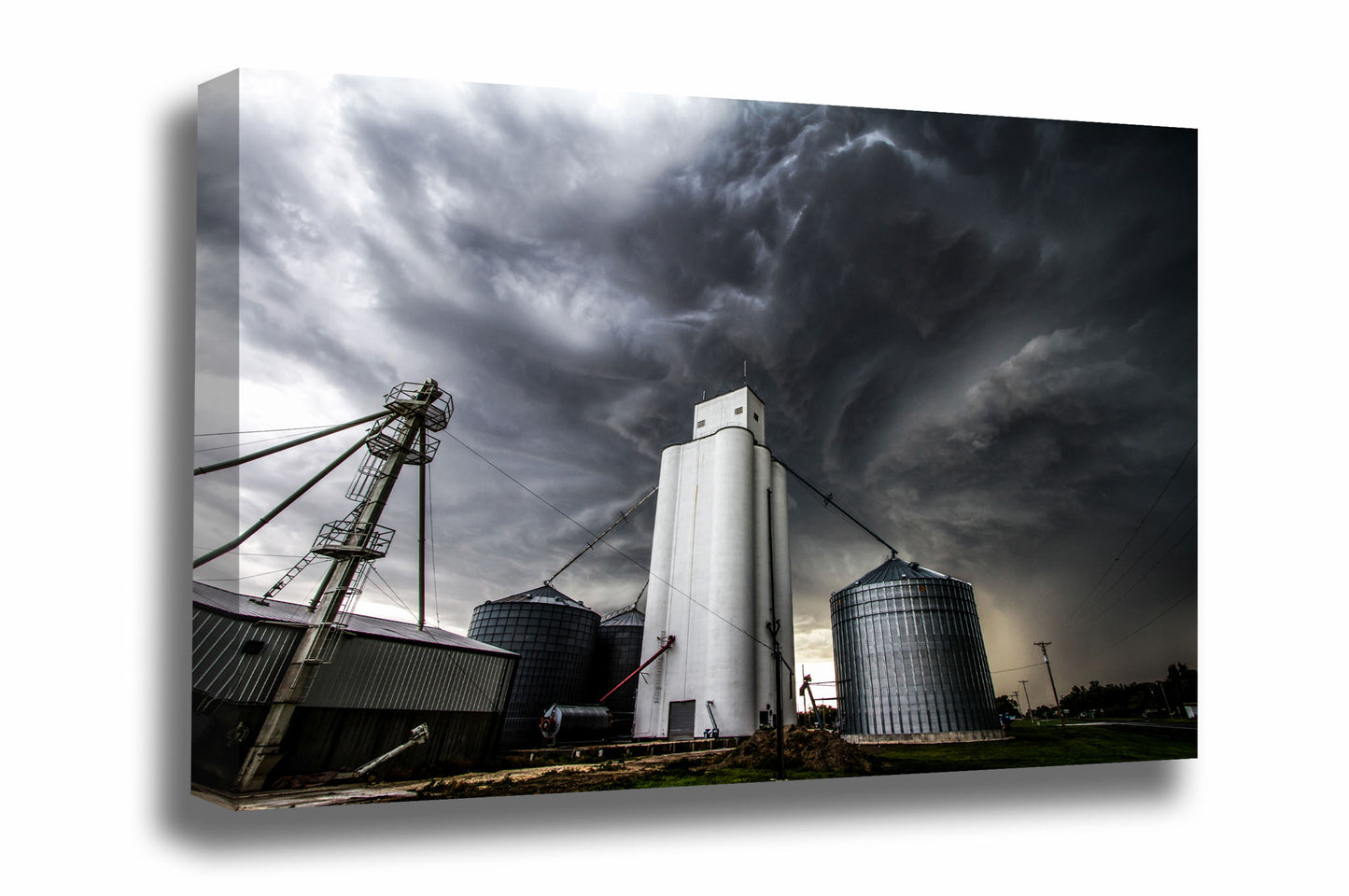 Canvas wall art of storm clouds swirling dramatically over a grain elevator in a small town in Kansas by Sean Ramsey of Southern Plains Photography.
