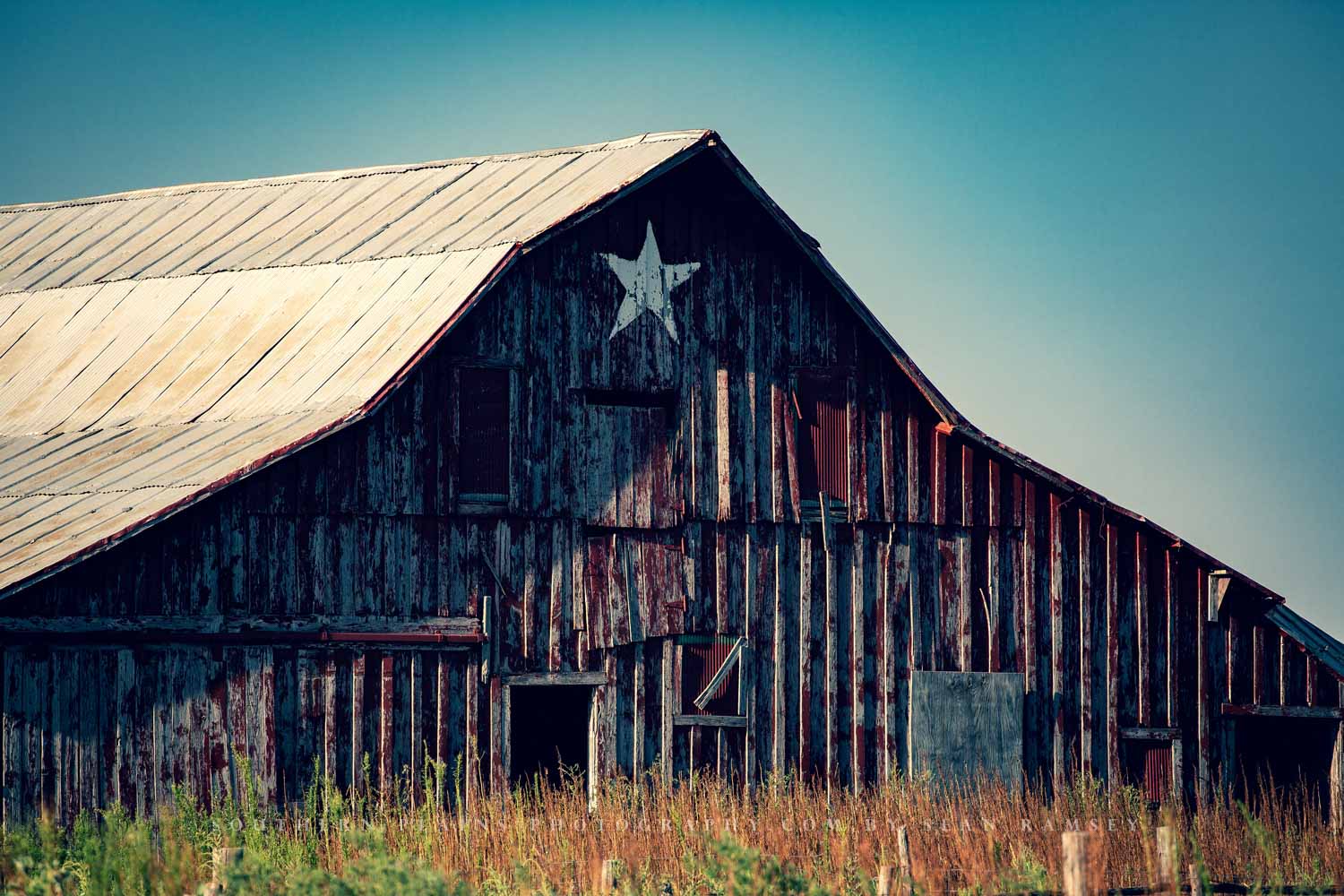 Country photography print of a rustic barn with a painted white star with a nostalgic feel captured on a summer day in Oklahoma by Sean Ramsey of Southern Plains Photography.