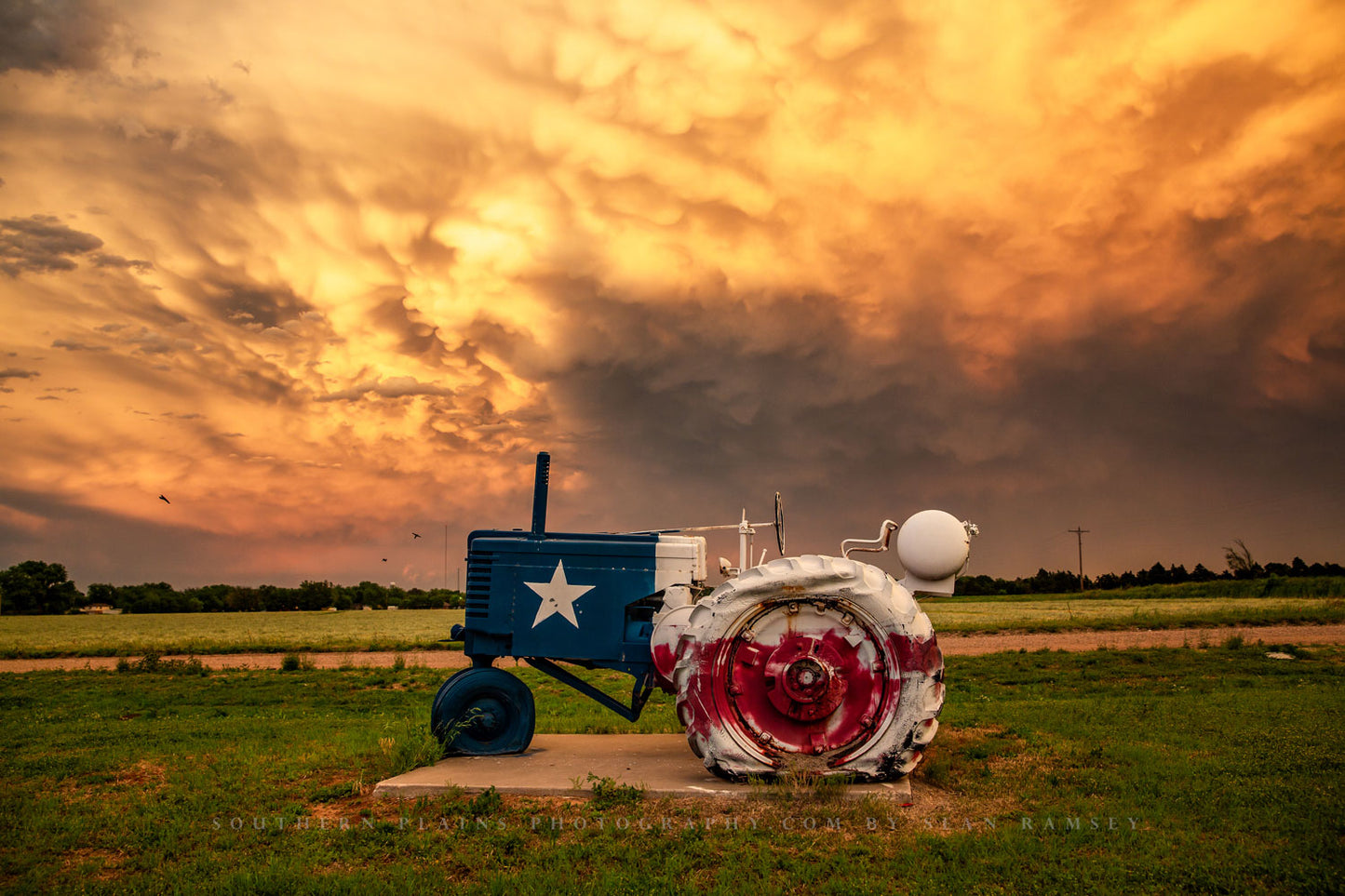 Country photography print of a tractor painted as the Lone Star flag on a stormy evening in Texas by Sean Ramsey of Southern Plains Photography.