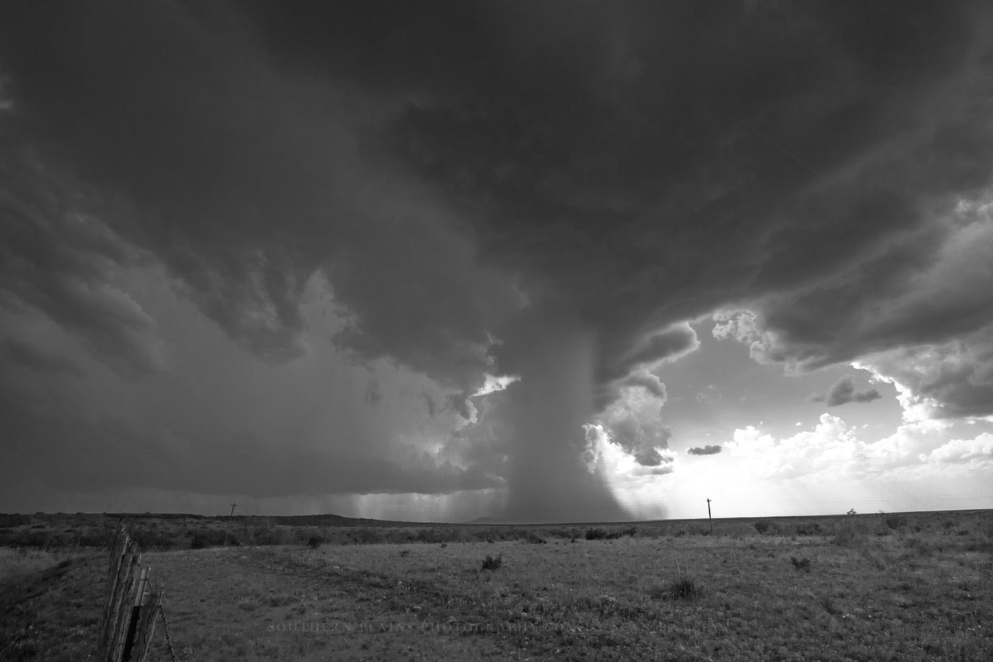 Storm photography print of a thunderstorm with a microburst dropping rain from high in the sky resembling a waterfall on a spring day in West Texas by Sean Ramsey of Southern Plains Photography.