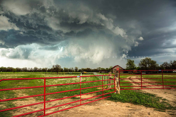 Storm photography print of an intense storm passing over a farm with red gates on a stormy spring day on the plains of Kansas by Sean Ramsey of Southern Plains Photography.