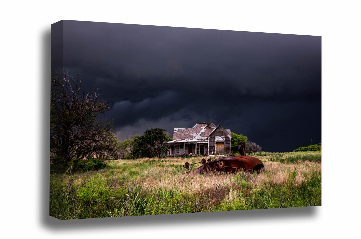Moody storm canvas wall art of an abandoned house and classic cotton gin on a stormy night in Texas by Sean Ramsey of Southern Plains Photography.