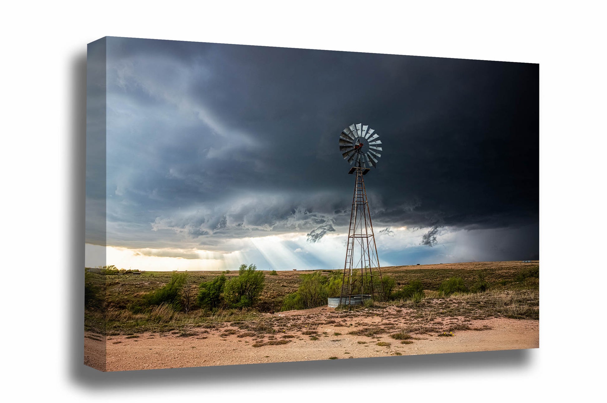 Canvas wall art of a windmill standing tall over the prairie as sunbeams shine through a thunderstorm on a stormy spring day in Texas by Sean Ramsey of Southern Plains Photography.